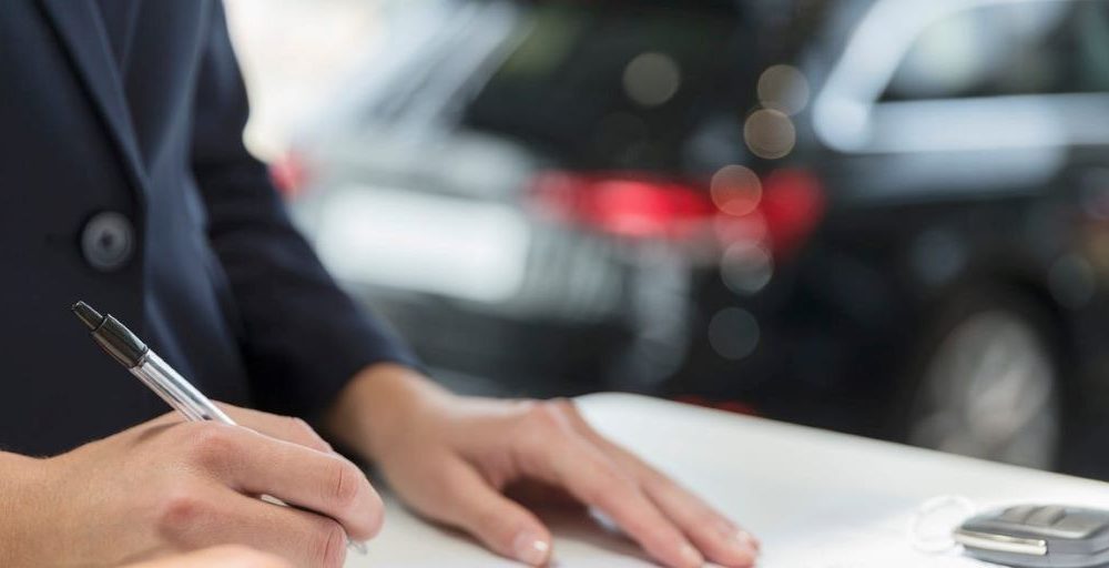 Illustration of a person reviewing a car lease agreement, representing steps to end a lease early without penalties