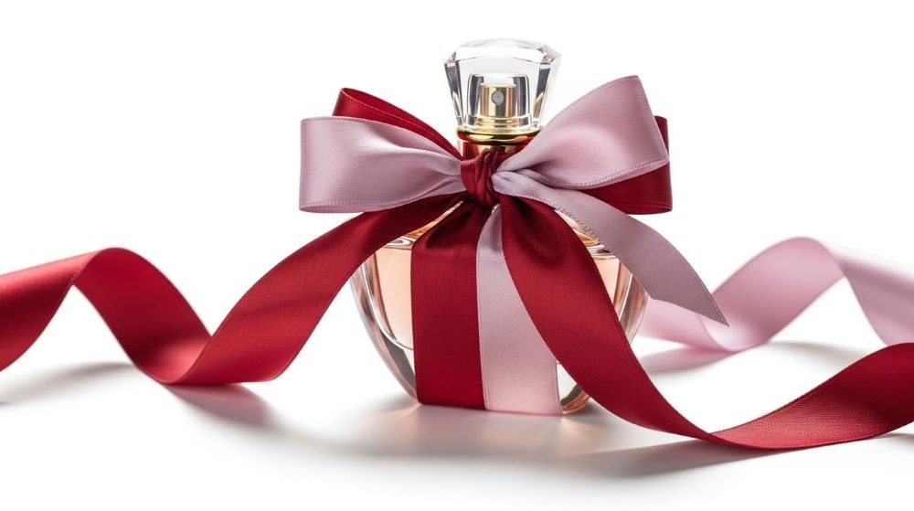 A luxury perfume bottle wrapped in ribbon as a romantic gift on a white background