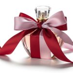 A luxury perfume bottle wrapped in ribbon as a romantic gift on a white background