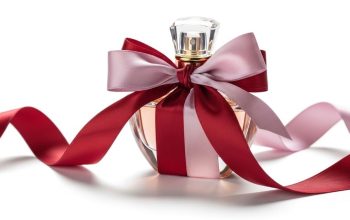 A luxury perfume bottle wrapped in ribbon as a romantic gift on a white background