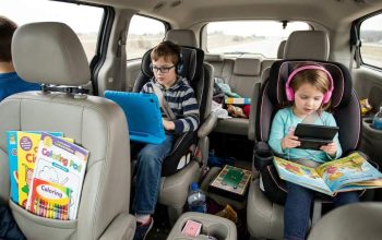 Family using tablet mount in car during Orlando road trip with kids watching movies comfortably