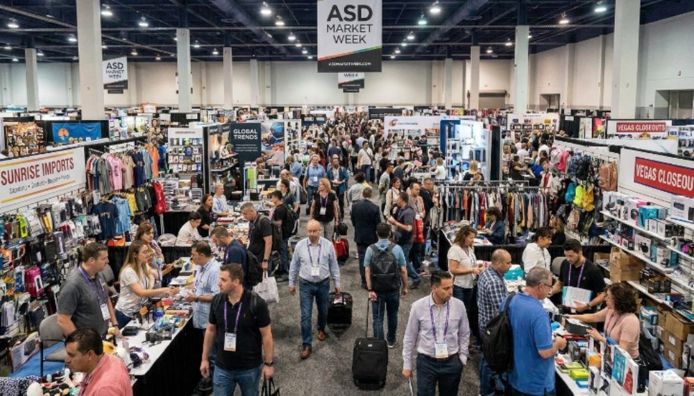 Crowded trade show floor at ASD Market Week Las Vegas with exhibitor booths and retail buyers