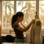Miami fashion creator preparing camera equipment before runway event