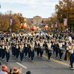 Marching band performing along the Benjamin Franklin Parkway during the Philadelphia Thanksgiving parade