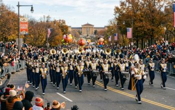 Marching band performing along the Benjamin Franklin Parkway during the Philadelphia Thanksgiving parade