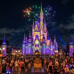 Magic Kingdom castle lit up for Halloween night celebration