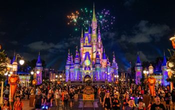 Magic Kingdom castle lit up for Halloween night celebration