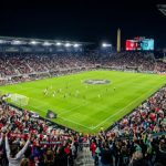 Thousands of soccer fans filling Audi Field in Washington DC for the 2026 NWSL Championship on November 21 under stadium lights at night